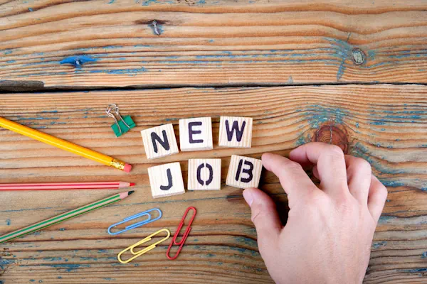 Picture of new job in scrabble tiles on a wooden table